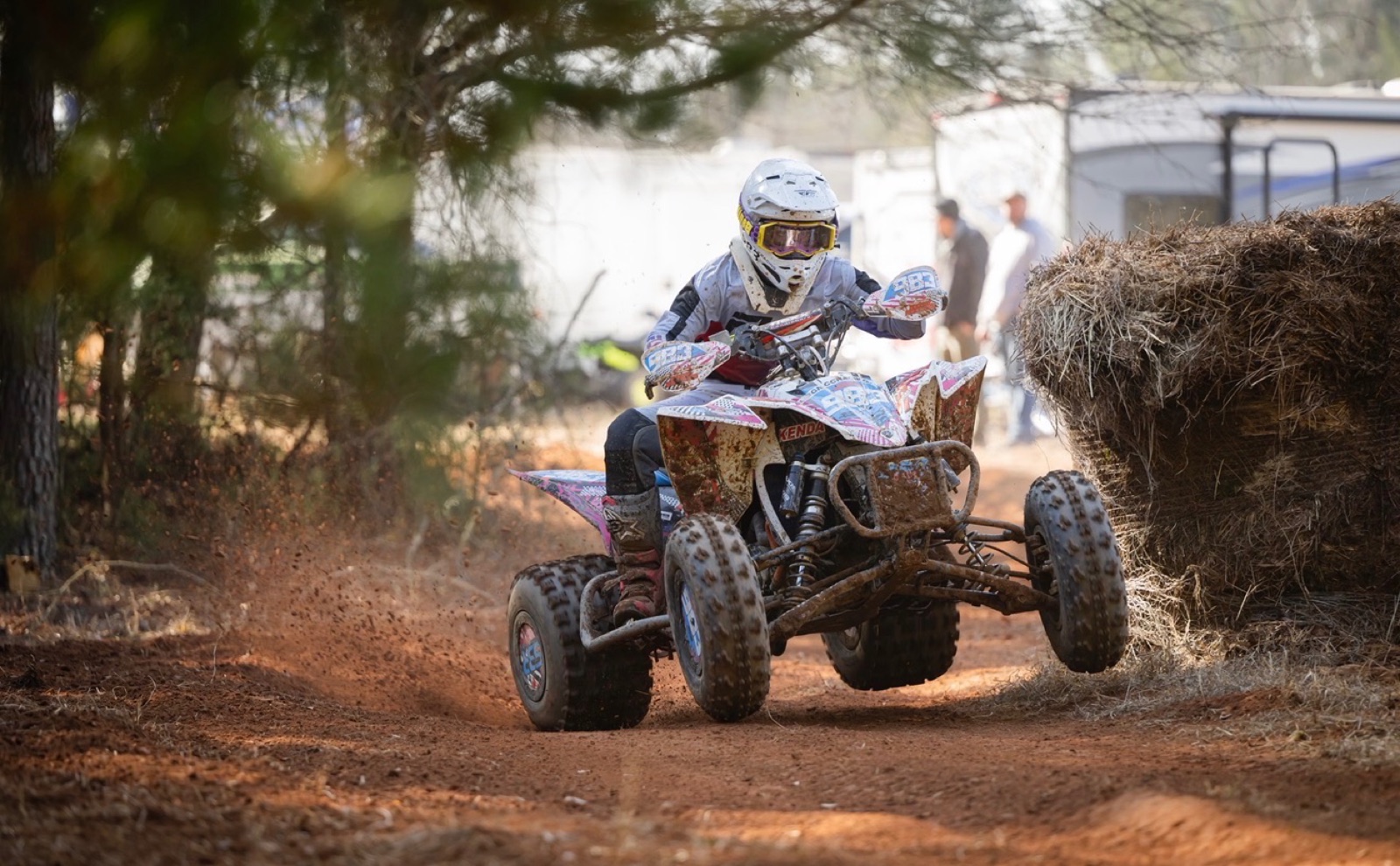 Andrea Rodgers cornering on her #983 quad — pit area trail