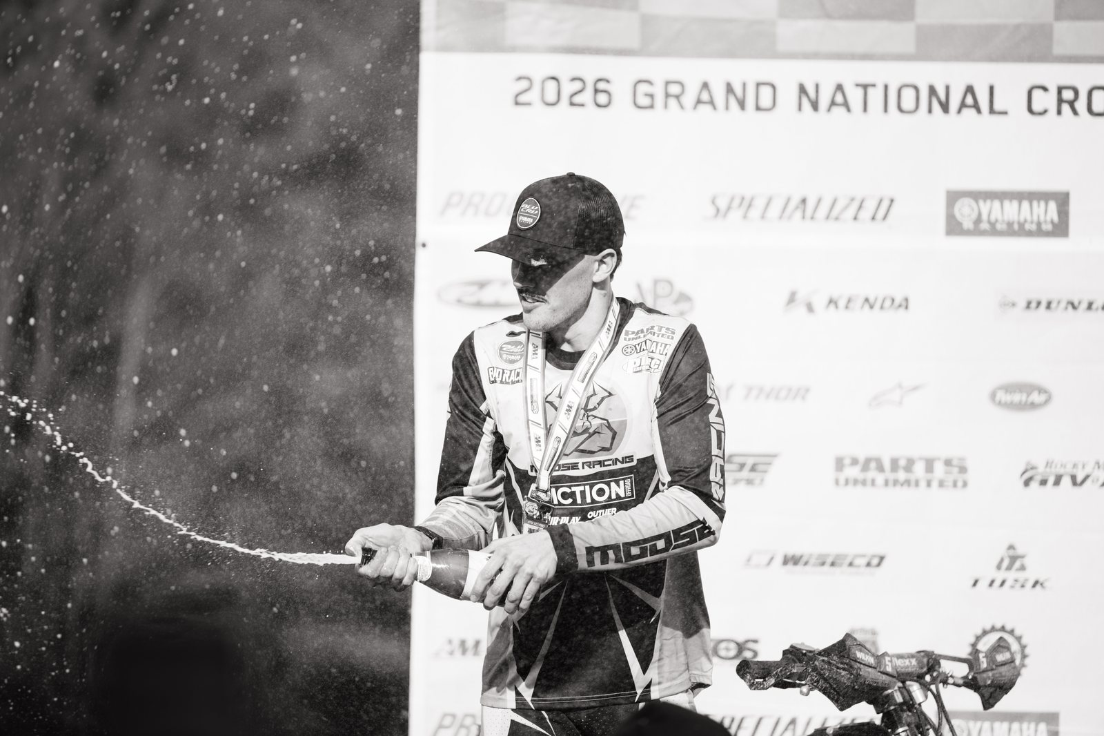 Wyatt Wilkin spraying champagne on the podium